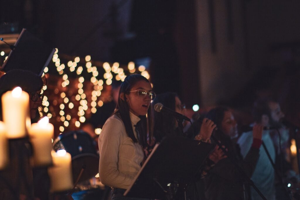 Lady singing at a night-time concert